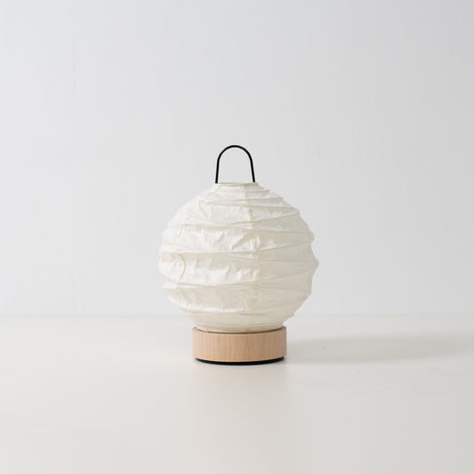 Japanese Paper Table Lamp "Yuhi", white, Mino Washi paper and wood - unlit round accent lamp from Japan on a white surface.