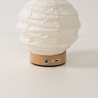 Japanese Paper Table Lamp "Yuhi", white, close-up of the wooden base and toggle switch for the cordless lamp.