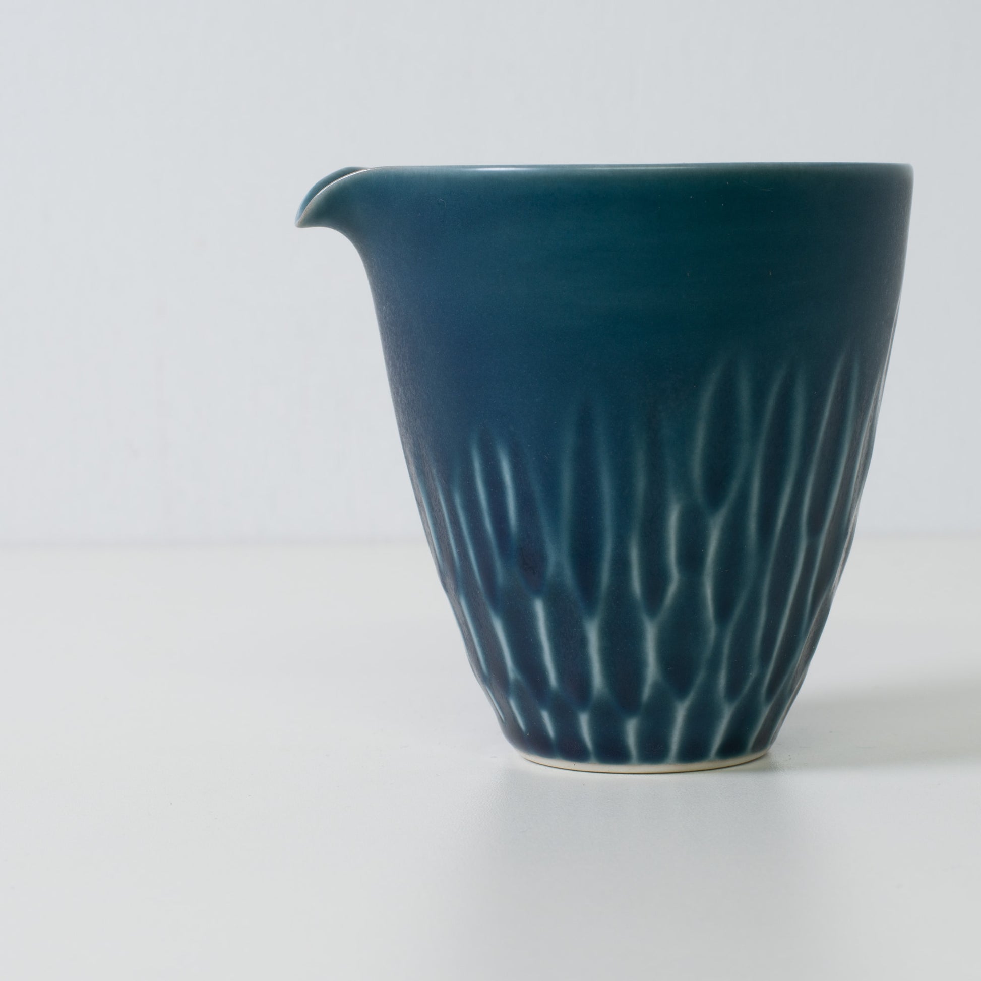 Matte lapis sake carafe, blue, porcelain - Close up of a Japanese sake carafe highlighting carved details