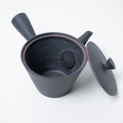 Open japanese teapot looking inside at the ceramic mesh strainer and lid of the black kyusu sencha pot
