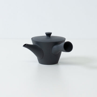 Side view of a black unglazed japanese teapot sencha kyusu showing the compact banko yaki clay design and spout.