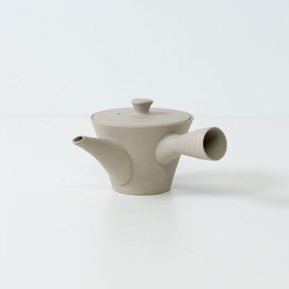 Side view of a white banko yaki japanese teapot with a side handle showing modern minimalist design for sencha brewing.