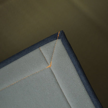 Japanese denim rush tatami area rug showing its urethane foam backing, providing comfortable cushioning for meditation.
