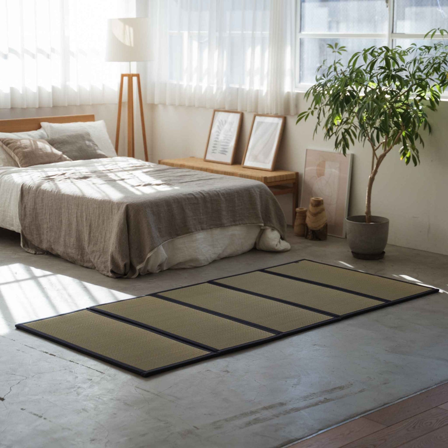 Five panel tatami mattress on a concrete bedroom floor serving as a breathable and healthy base for a futon.
