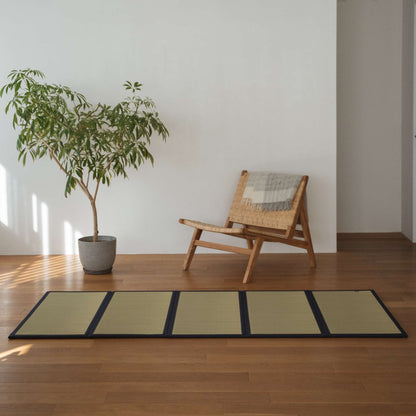 Five panel undyed tatami mat laid on a wooden living room floor offering a smooth and natural zen decor.
