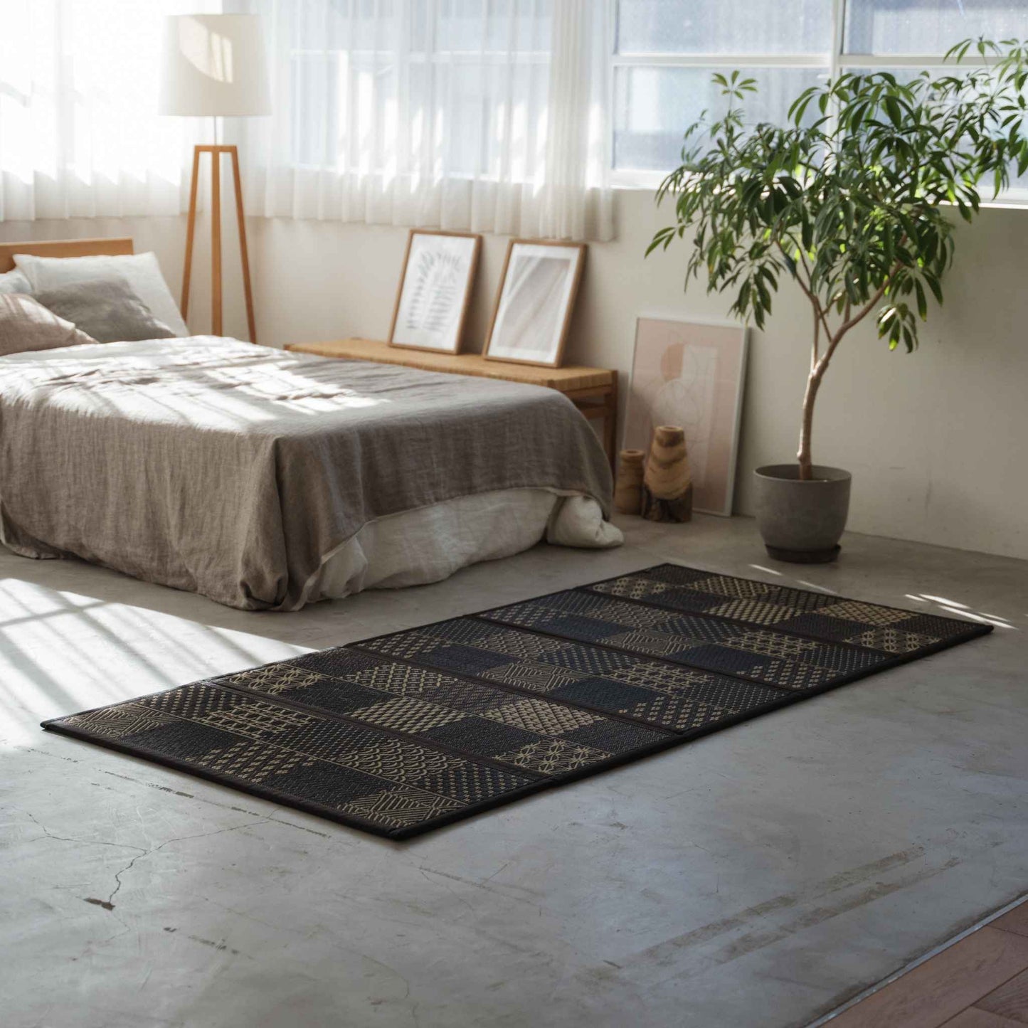 Five panel edokomon tatami mattress laid on a bedroom floor serving as a breathable and foldable base for a futon.