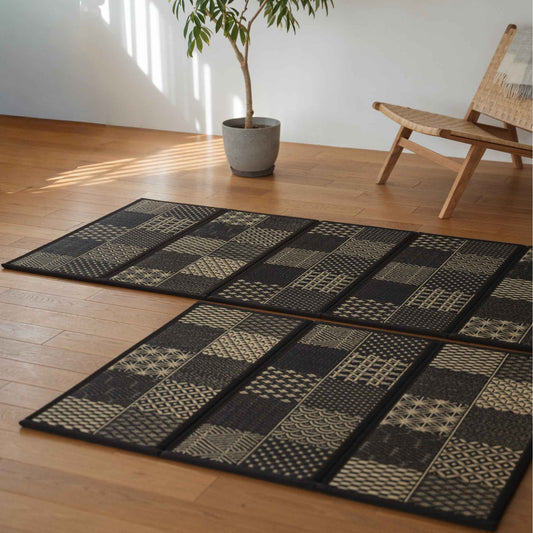Detailed view of edokomon tatami mat panels on a floor showing unique geometric cuts and black rush grass texture.