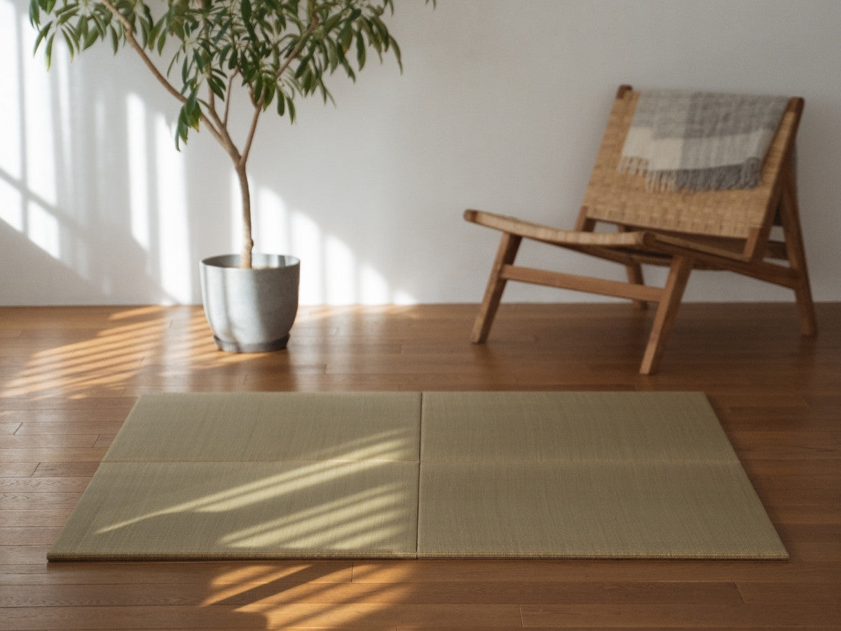 Four square tatami mat panels laid on a wooden living room floor creating a natural zen decor corner.