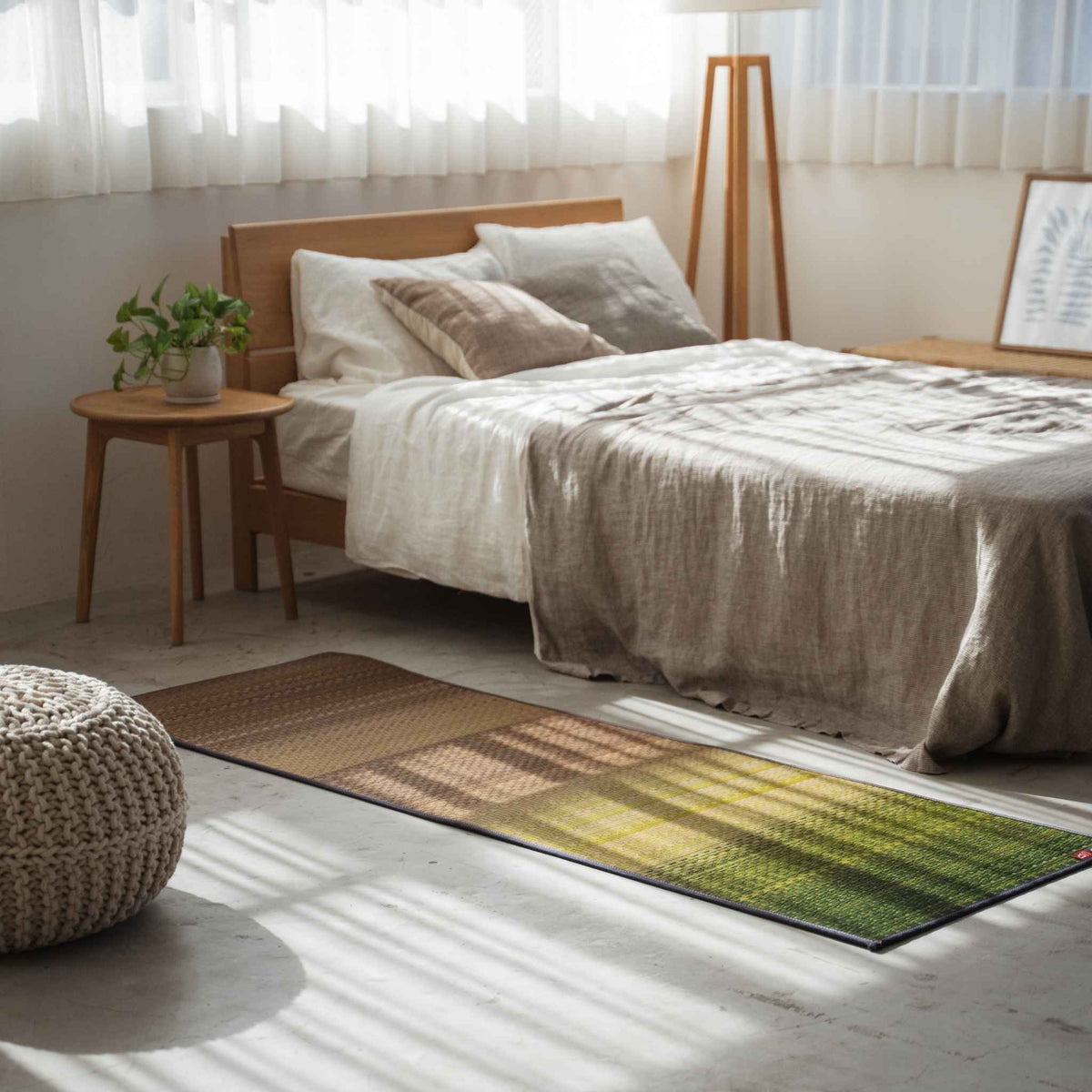 Green gradient tatami mat placed on a bedroom floor creating a natural and calming meditation space.