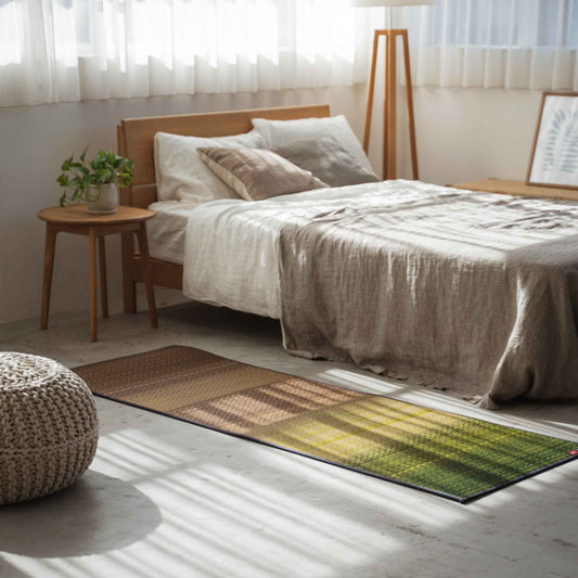 Green gradient tatami mat placed on a bedroom floor creating a natural and calming meditation space.