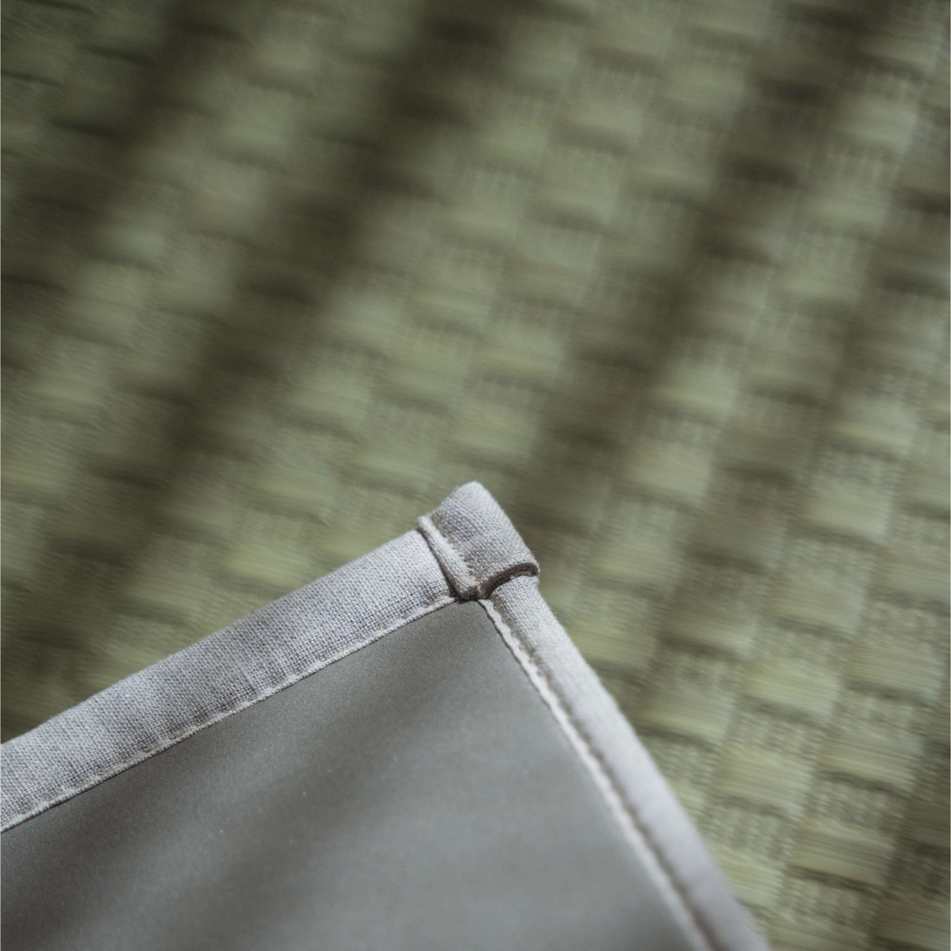 Corner detail of a natural tatami mat showing the eco friendly non slip TPE backing for yoga stability