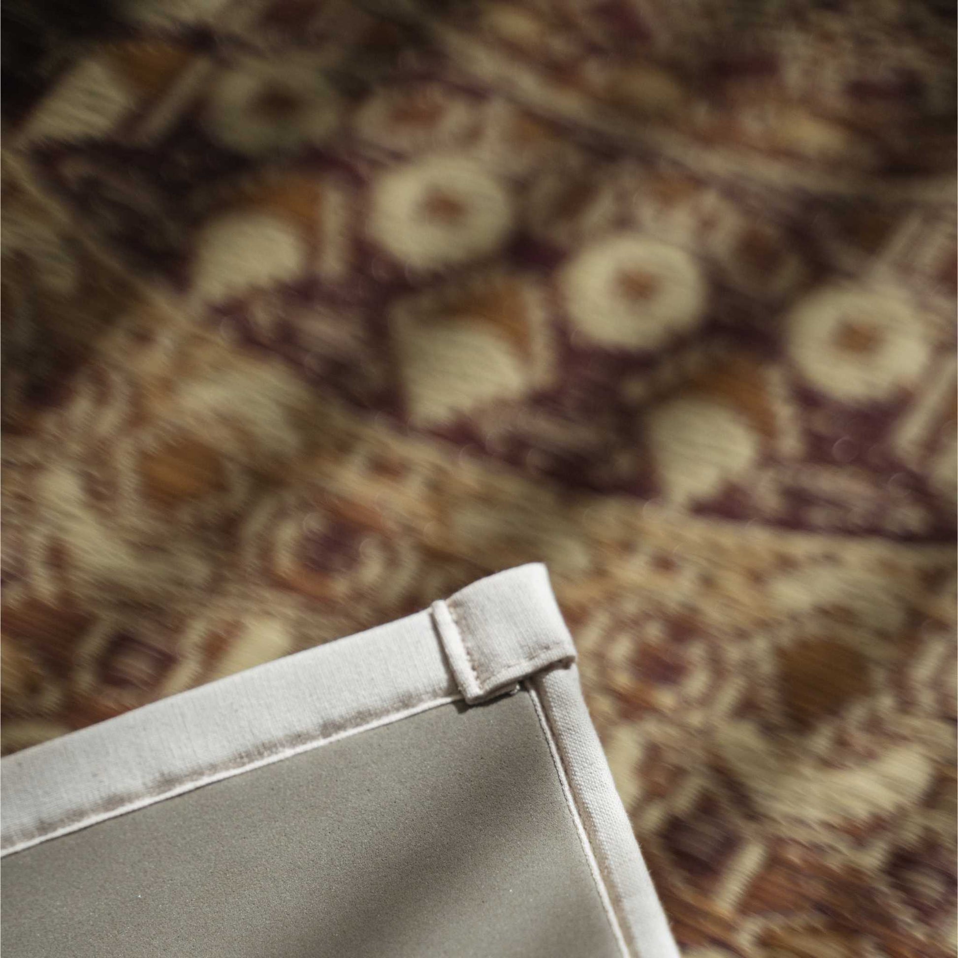 Corner detail of a brown tatami mat showing the eco friendly TPE backing that ensures stability for yoga.