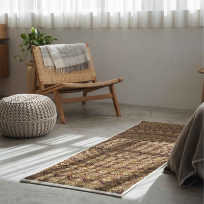 Brown mandala tatami mat laid on a concrete living room floor serving as a zen decor runner next to a chair.
