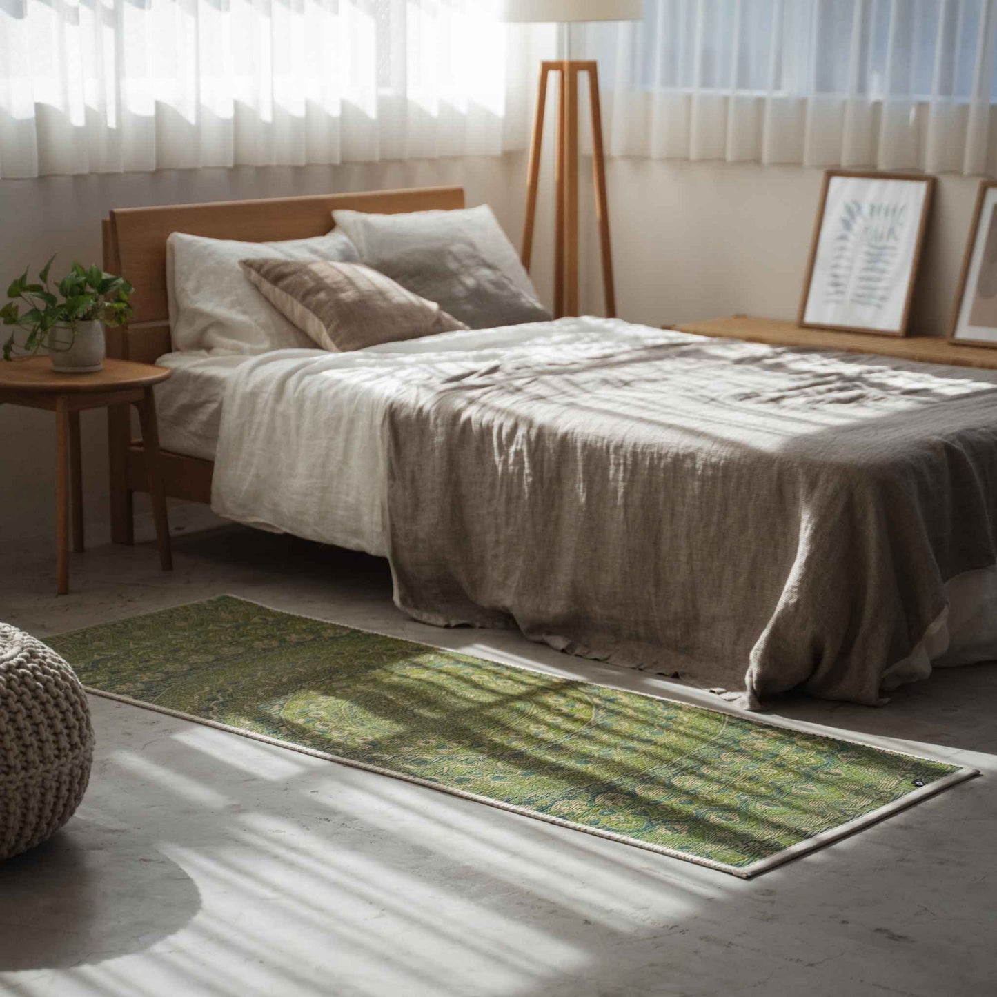Green tatami mat with mandala pattern serving as a stylish bedside runner in a sunlit bedroom.