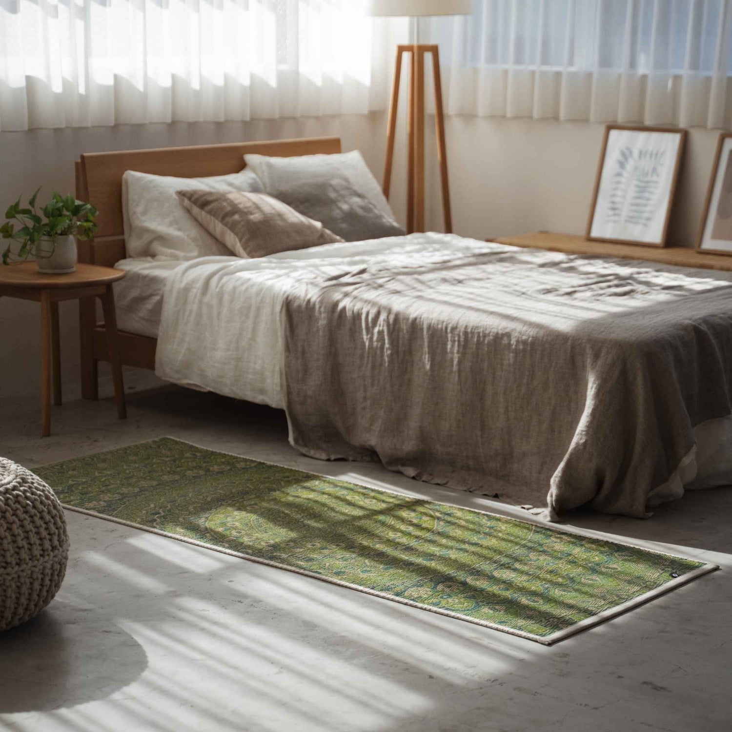 Green tatami mat with mandala pattern serving as a stylish bedside runner in a sunlit bedroom.