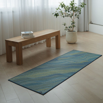 Japanese Tatami Yoga Mattress "Marble" Blue placed on a wooden floor in a minimalist living room for home yoga practice.