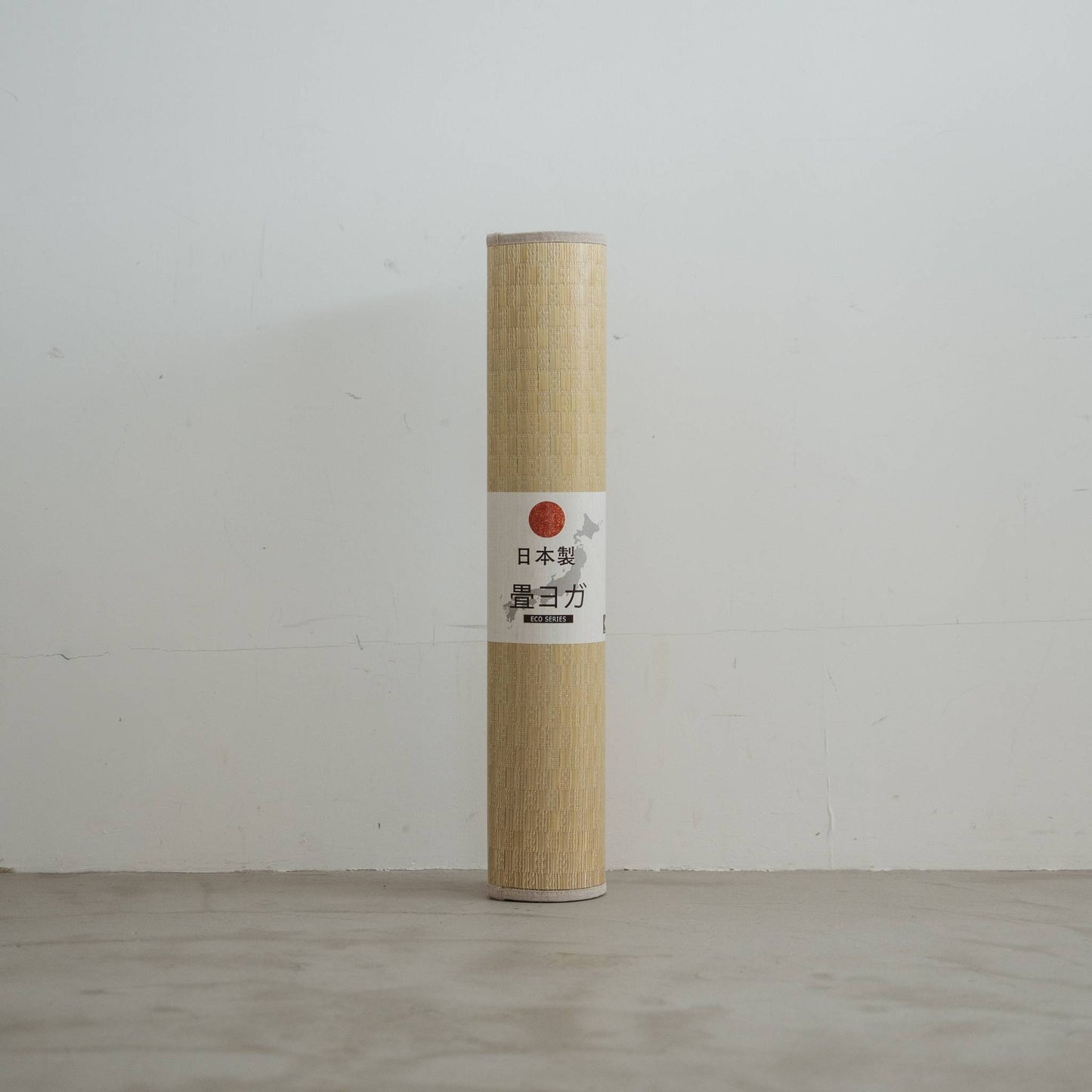 Upright rolled tatami mat displaying a woven green pattern made of rush grass for minimal japanese decor.