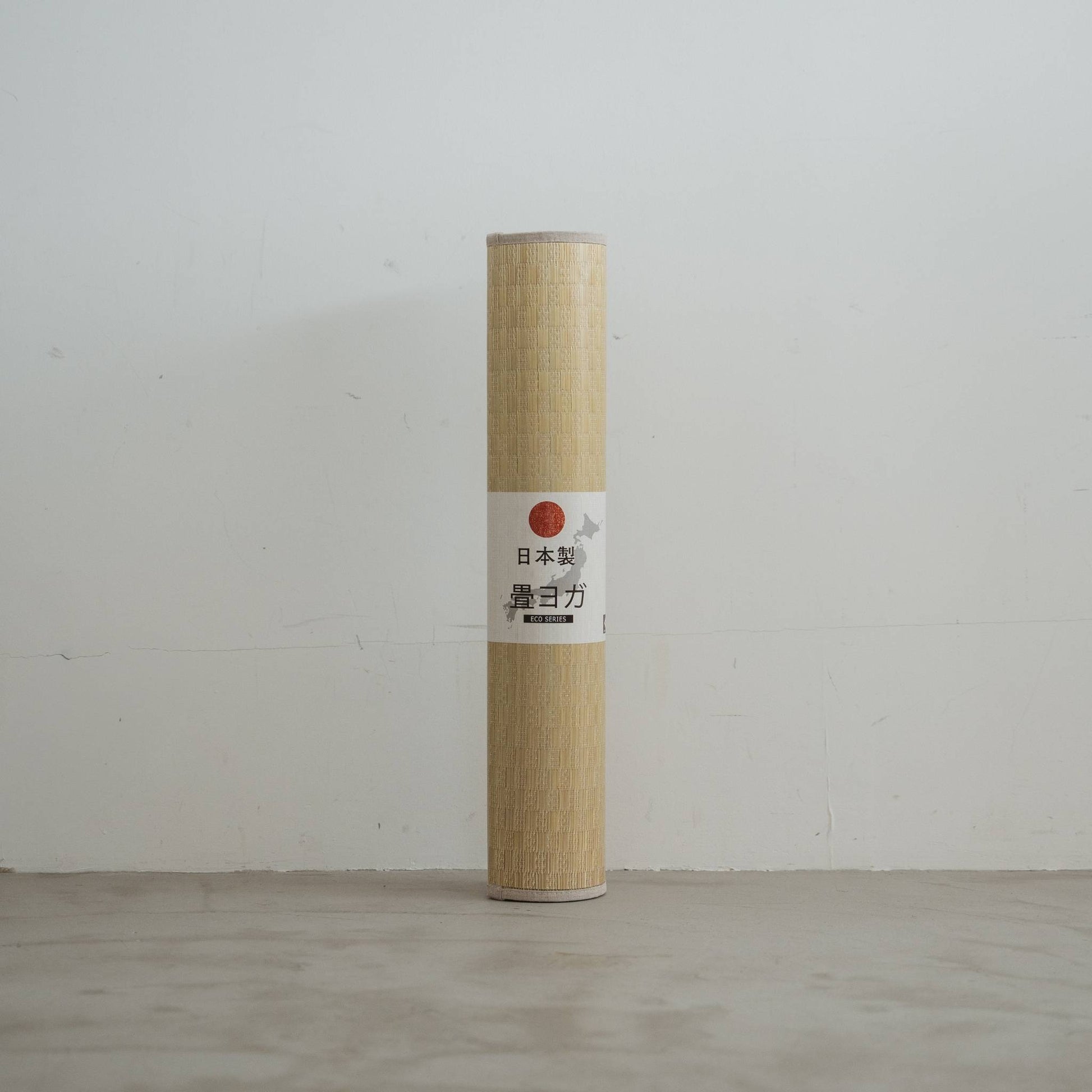 Upright rolled tatami mat displaying a woven green pattern made of rush grass for minimal japanese decor.