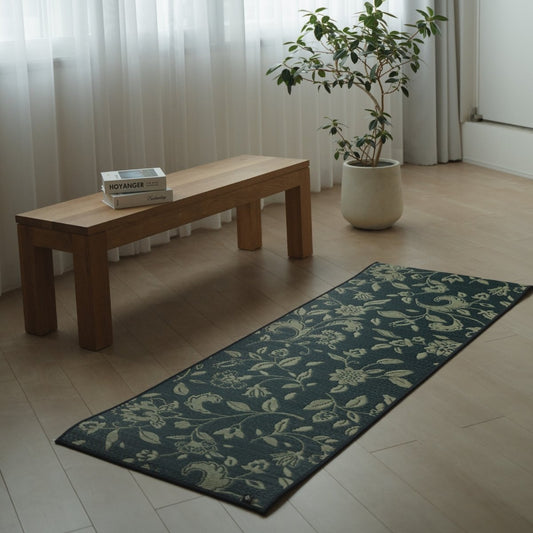 Japanese Tatami Yoga Mattress "Sarasa" Navy on a wooden floor in a minimalist living room for home yoga or meditation.