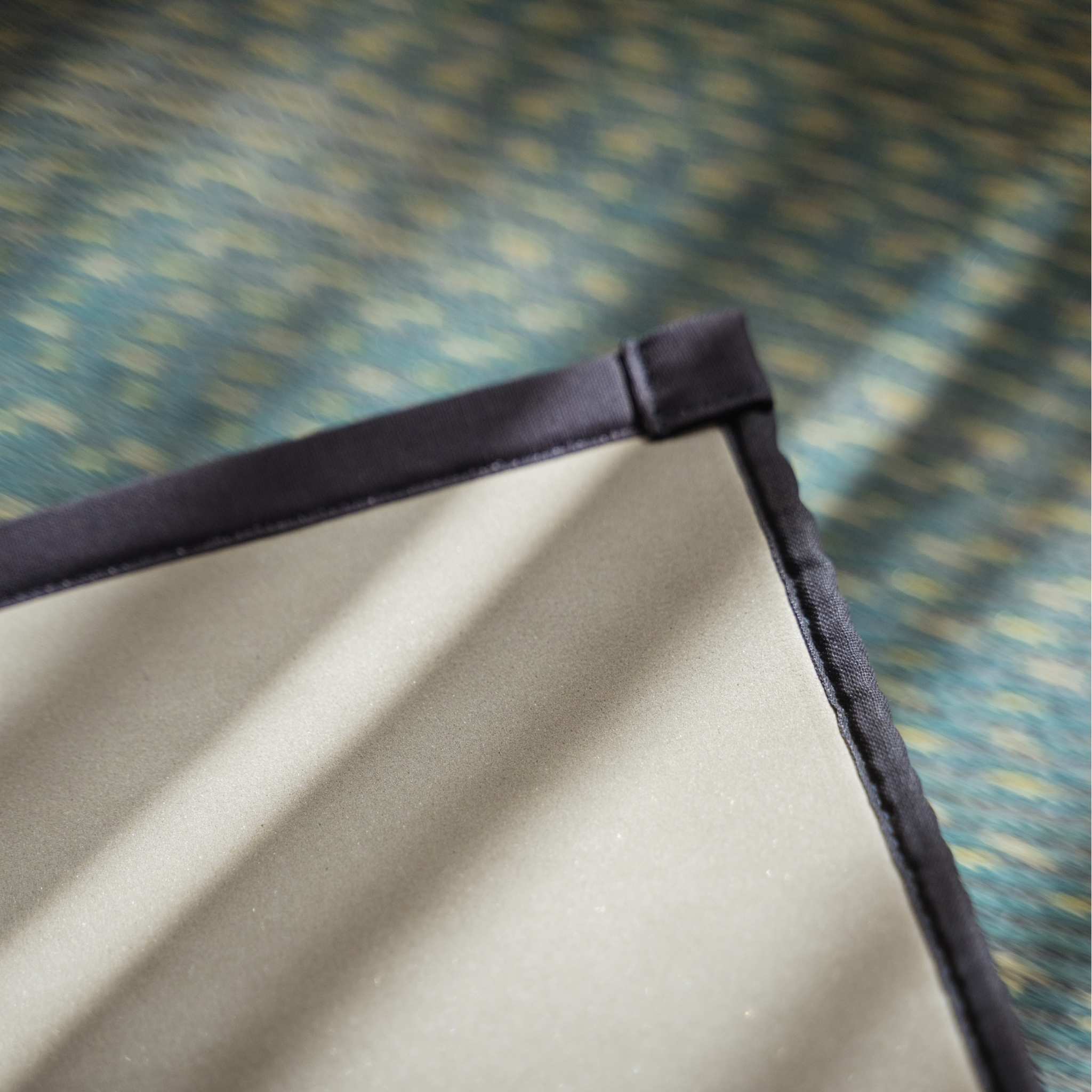 Corner detail of a blue tatami mat showing the eco friendly non slip TPE backing for stability.