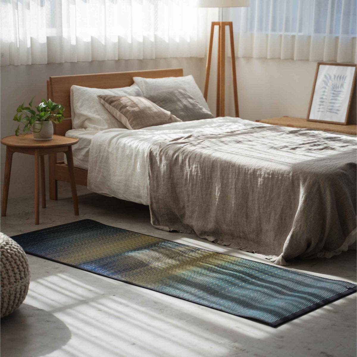 Blue gradient tatami mat placed on a bedroom floor creating a calming zen space for meditation.