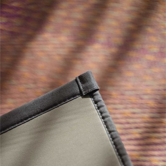 Corner detail of a red tatami mat showing the eco friendly non slip TPE backing for yoga stability