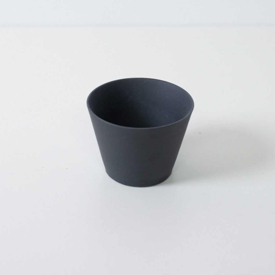 High angle view of a black ensui japanese tea cup showing the thin rim and conical stoneware form