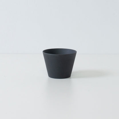 Single black japanese tea cup ensui with a matte unglazed texture and modern cone shape design