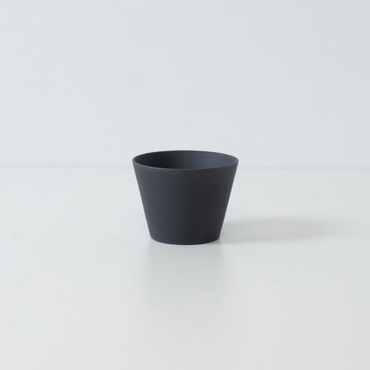 Single black japanese tea cup ensui with a matte unglazed texture and modern cone shape design