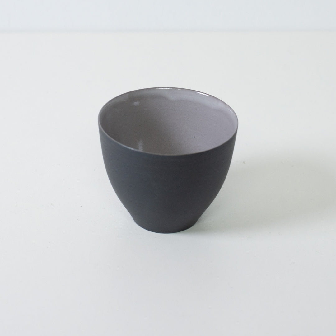 High angle view of modern japanese tea cups showing contrast between black unglazed exterior and glossy grey interior