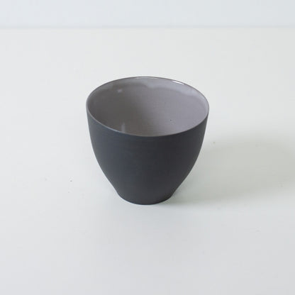 High angle view of modern japanese tea cups showing contrast between black unglazed exterior and glossy grey interior