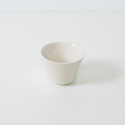 White kodai japanese tea cup featuring a traditional high footed base and glossy crackle glaze finish.