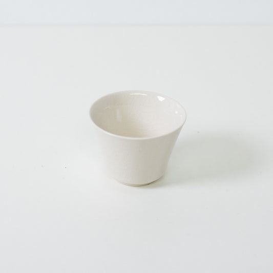 White kodai japanese tea cup featuring a traditional high footed base and glossy crackle glaze finish.