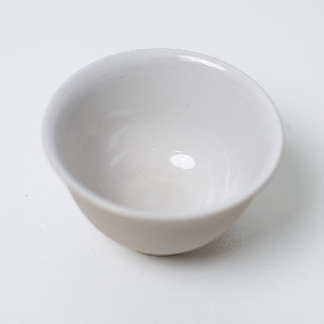 Interior close-up of a kumidashi chawan revealing the glossy white glaze for tea color
