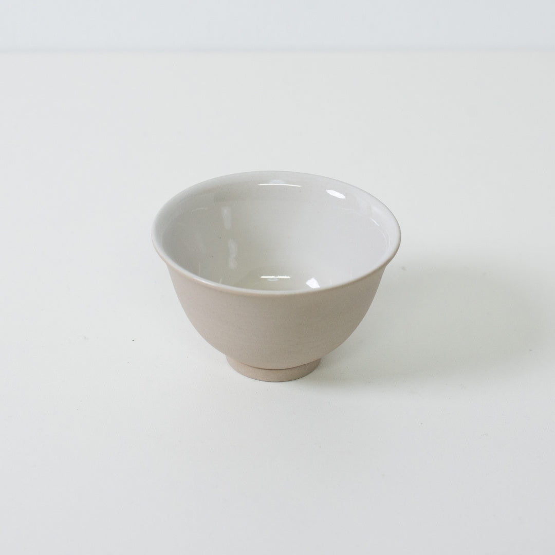 High angle view of a wide mouth Japanese tea cup showing the contrast between clay and glaze.