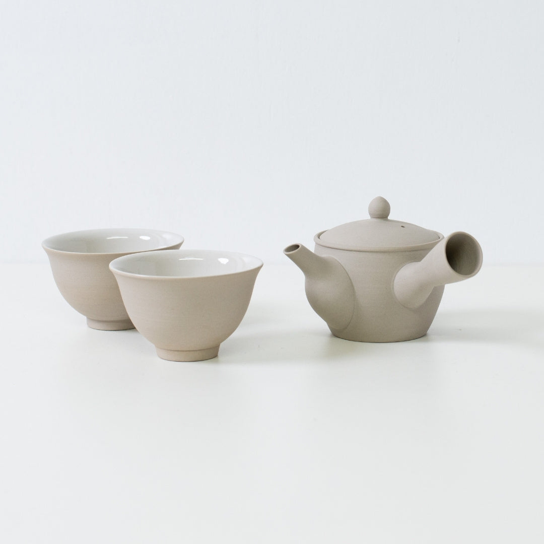 Minimalist Japanese tea set featuring a fuyo kyusu teapot and two kumidashi cups on a white table