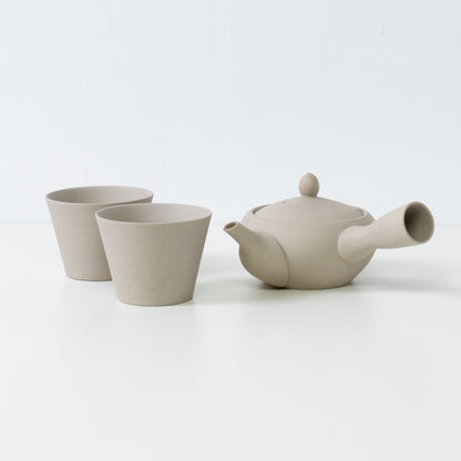 Beige white japanese tea set with a monks bowl kyusu teapot and matching stone texture tea cups.