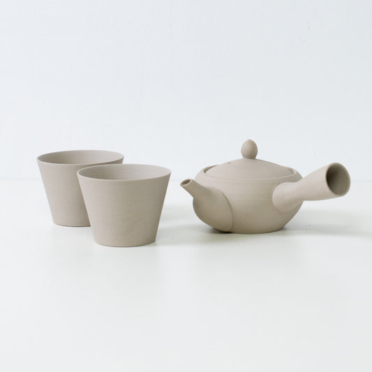 Beige white japanese tea set with a monks bowl kyusu teapot and matching stone texture tea cups.