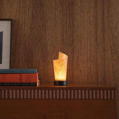 Lit Japanese paper table lamp "Maki" Cedar Bark casting soft upward light as an ambient lamp on a mid-century modern console table.