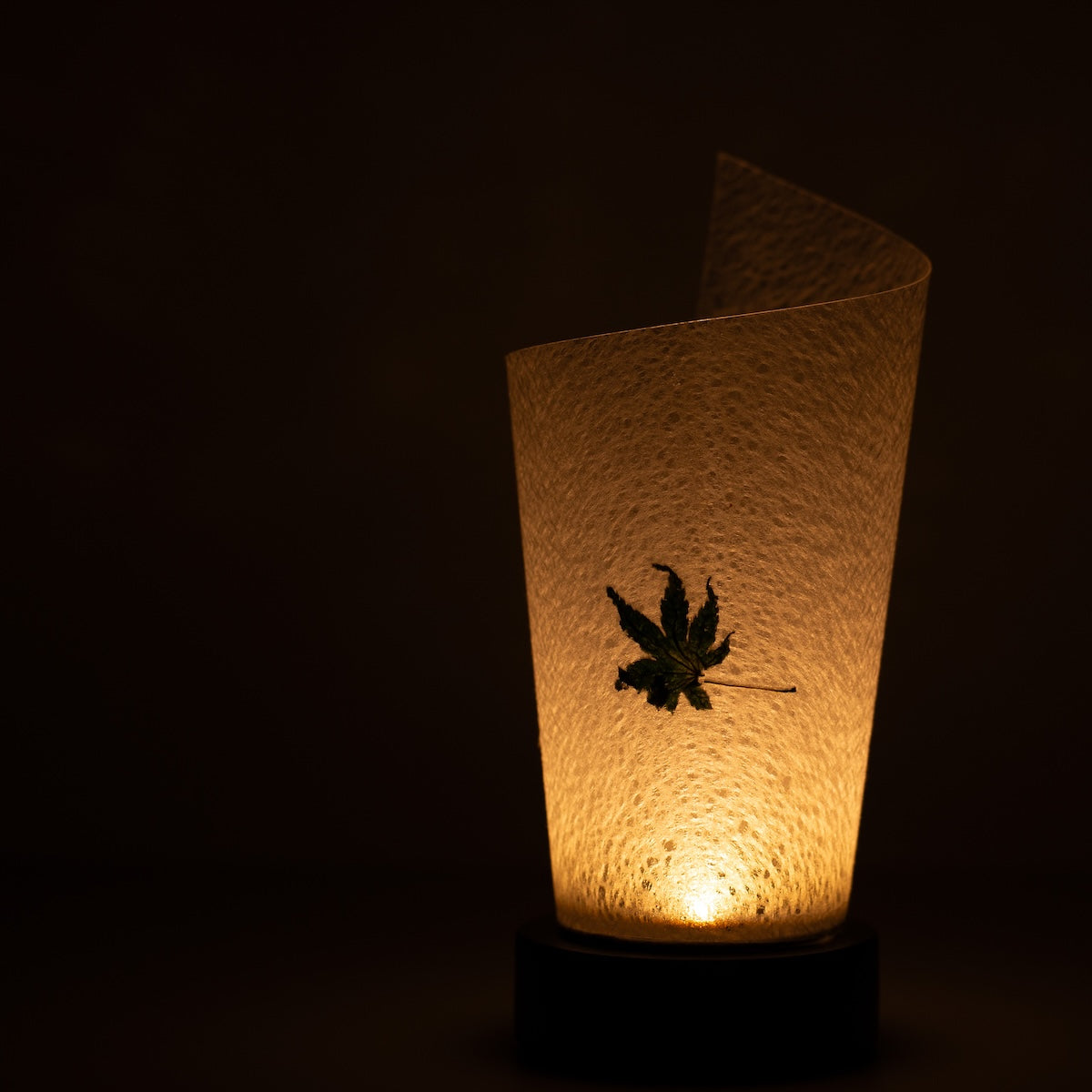 Japanese Paper Table Lamp "Maki", white, Mino Washi paper - close-up of illuminated wabi sabi table lamp showing texture.