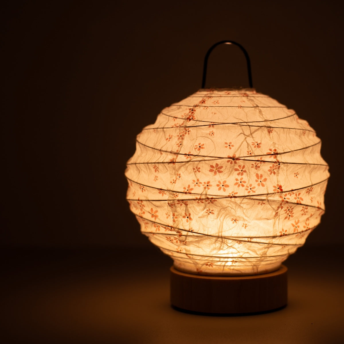 Japanese Paper Table Lamp "Yuhi" Sakura, white, Mino Washi paper - close-up of illuminated wabi sabi table lamp showing texture.