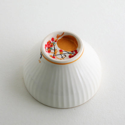 Close-up of Japanese matcha chawan bowl “Waraku” Moon, showing a hand-painted gold moon design on white porcelain with elegant sogi texture and gold rim.