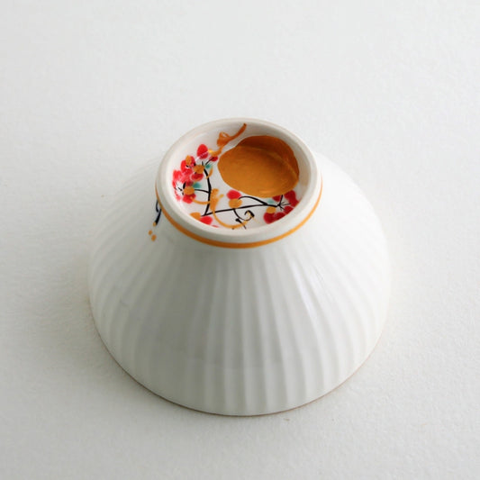 Close-up of Japanese matcha chawan bowl “Waraku” Moon, showing a hand-painted gold moon design on white porcelain with elegant sogi texture and gold rim.