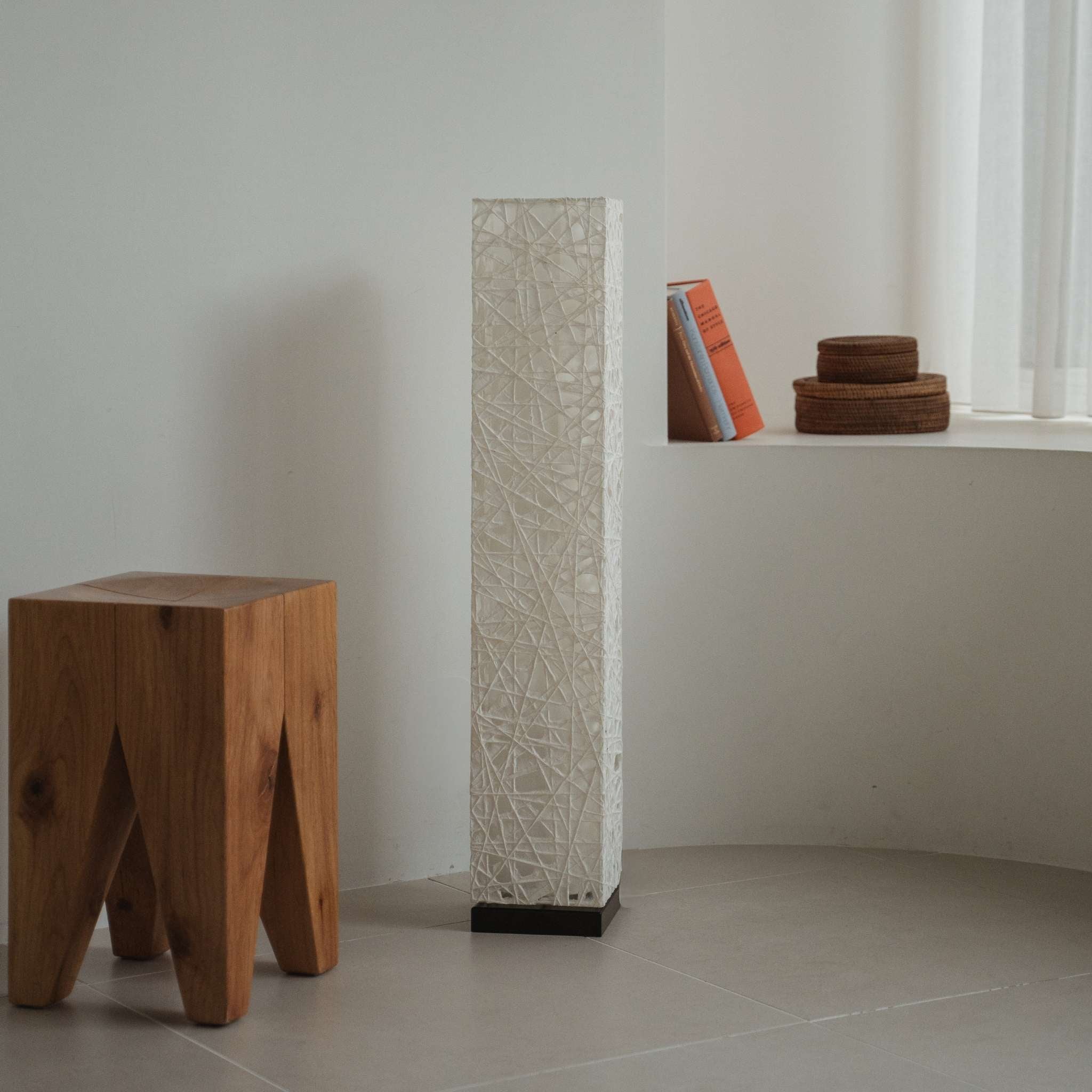 Modern white Japanese floor lamp Me Look 01 positioned on a tiled floor in a bright minimalist corner