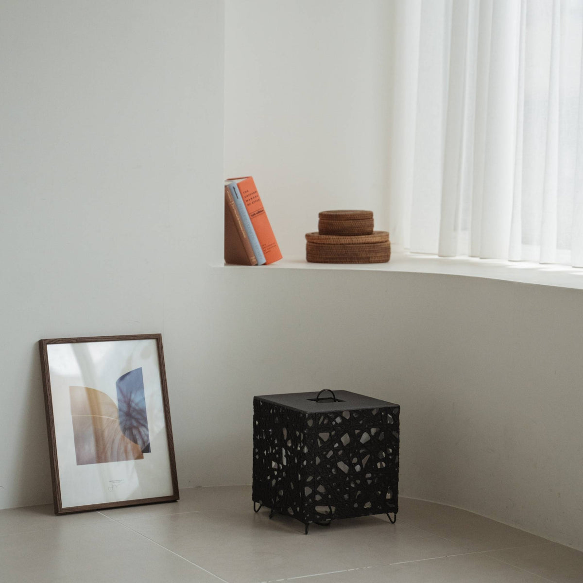 Modern black Japanese floor lamp Me-Look 03 black sitting unlit on a white tiled floor in a minimalist interior corner.