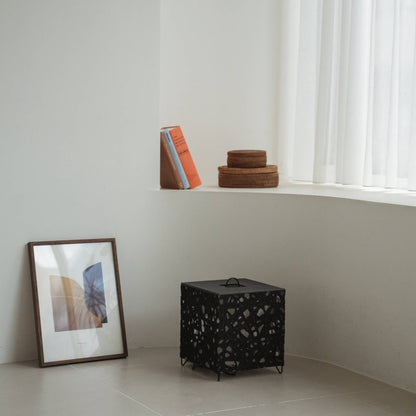 Modern black Japanese floor lamp Me-Look 03 black sitting unlit on a white tiled floor in a minimalist interior corner.