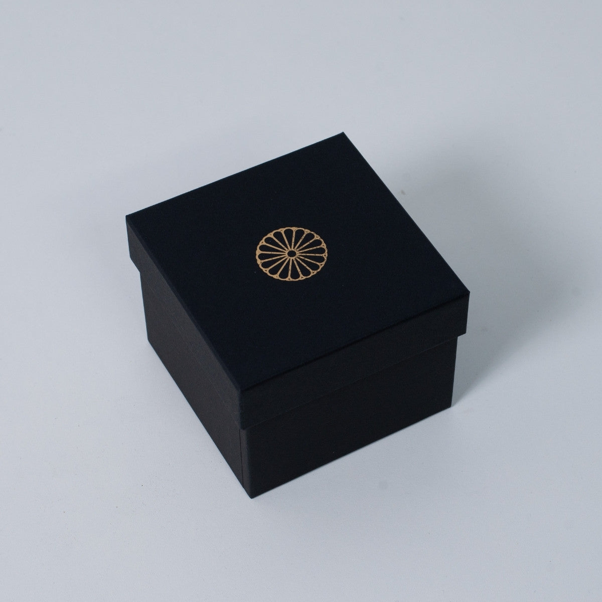 Closed black square Ninshu's box for Japanese incense burner pottery gifts, featuring a gold imperial chrysanthemum crest on the lid.