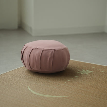 Rose Japanese meditation cushion zafu, placed on a tatami mat in a Japandi style room for a daily zen routine.