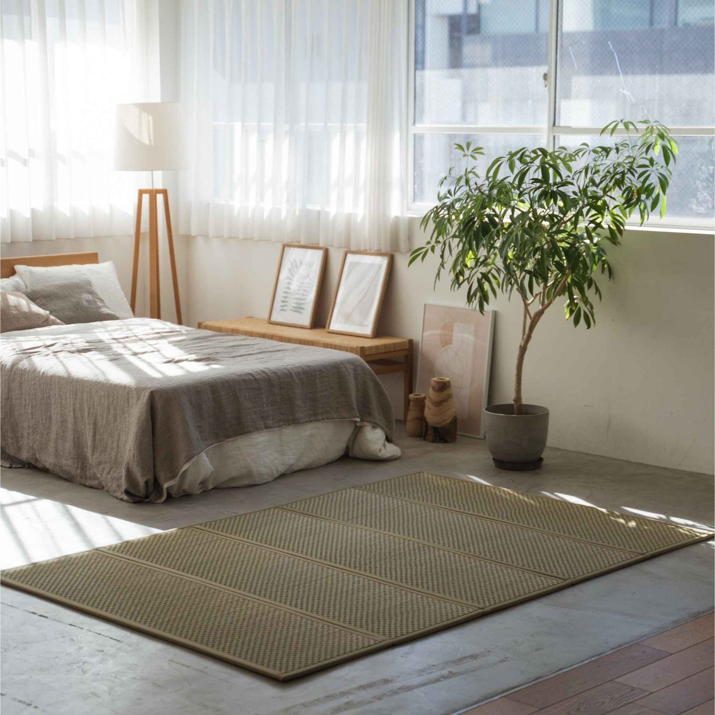 Double size tatami mat spread on a sunlit bedroom floor creating a natural meditation space and zen vibe.