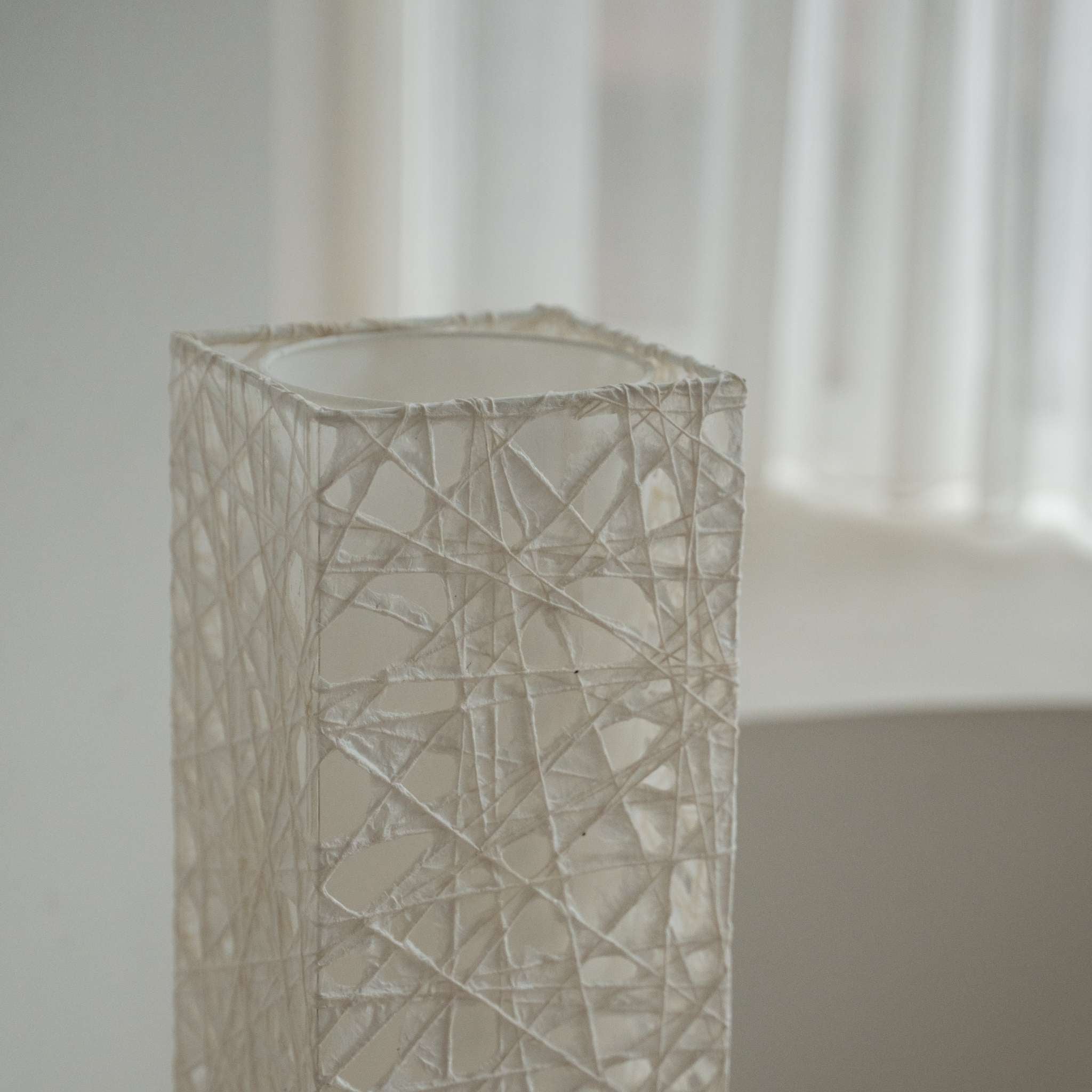 Detail shot of the translucent white Melook paper texture showing the fibrous web pattern of the lamp shade